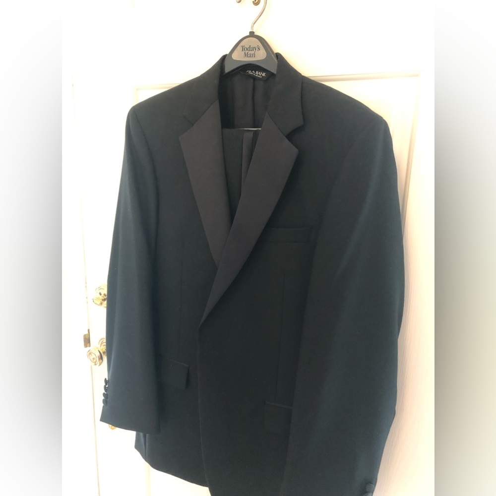 Black single breasted Tuxedo suit.  Satin black lapels. Worn 1 time.  100% wool